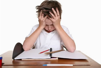 A young boy struggling with schoolwork
